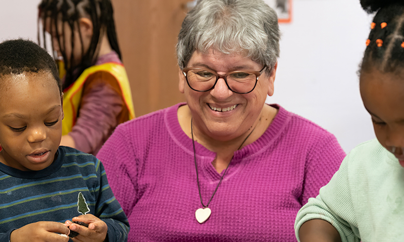 Photo of Jo Ann working with children in a classroom