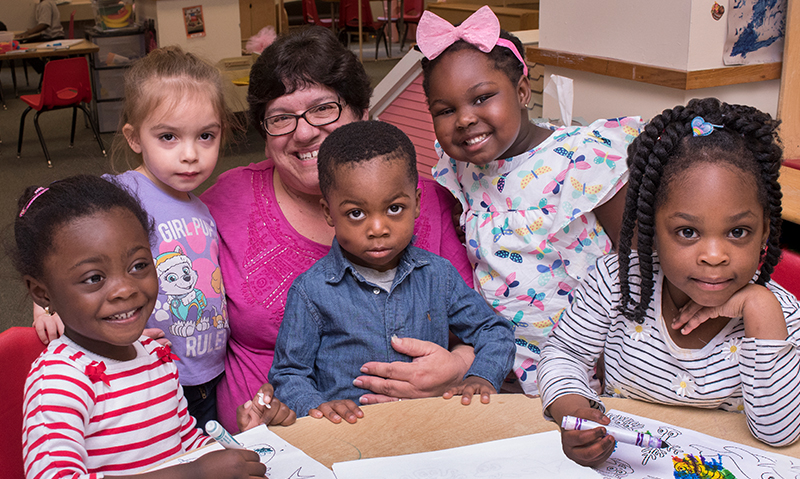 Photo of Jo Ann and a group of children